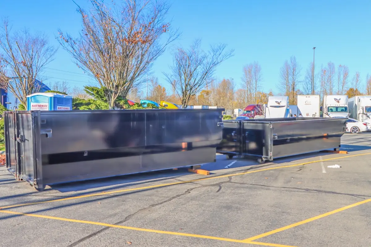 Professional dumpster rental service with roll-off container on residential driveway in Brigham City